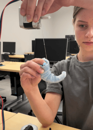 Female student holds and observes material